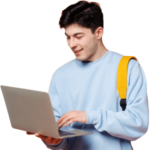 Male student in light blue jumper using laptop